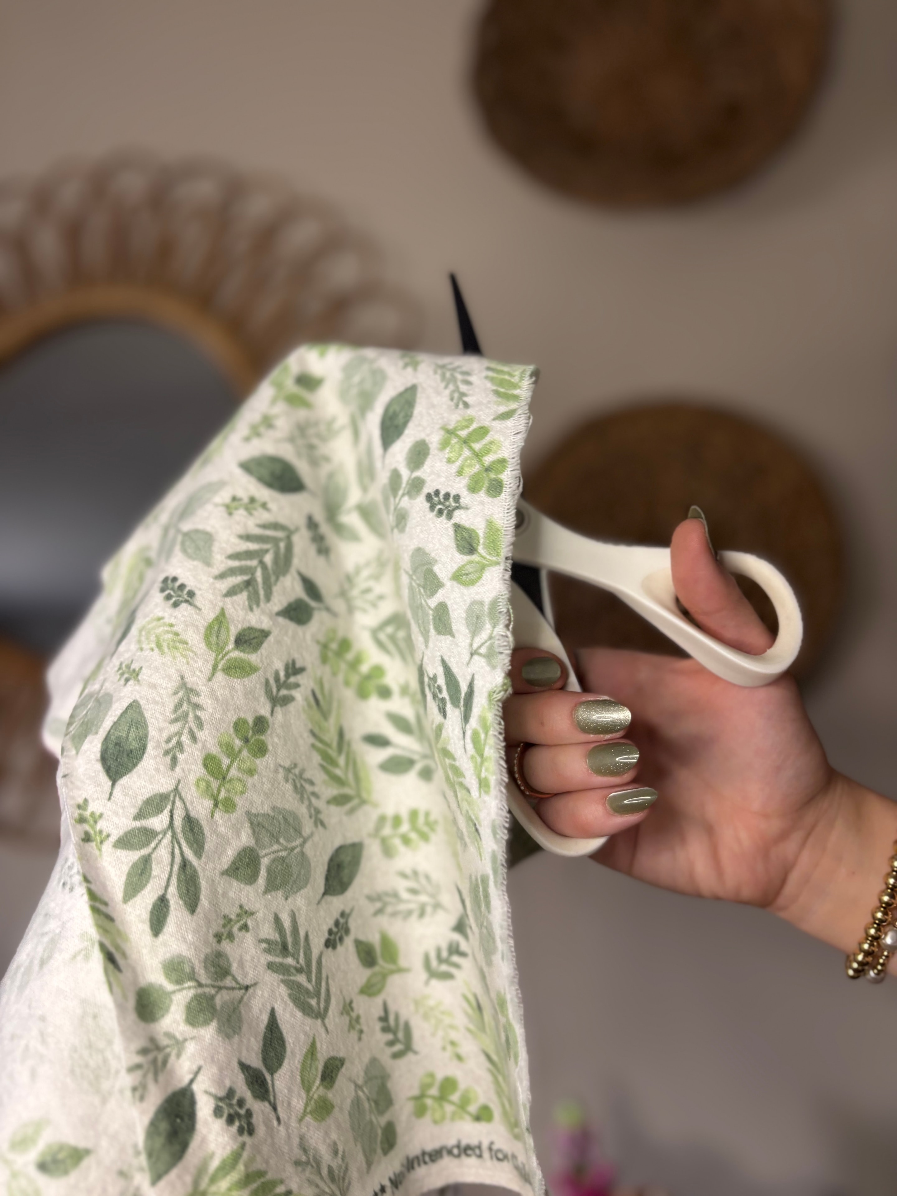 Maker sewing handmade cotton goods at a kitchen table